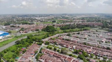 Top Aerial View Of Housing And City In Malaysia With Beautiful Mountain Views and Trees