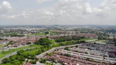 Top Aerial View Of Housing And City In Malaysia With Beautiful Mountain Views and Trees