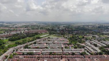 Top Aerial View Of Housing And City In Malaysia With Beautiful Mountain Views and Trees
