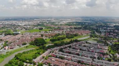 Top Aerial View Of Housing And City In Malaysia With Beautiful Mountain Views and Trees