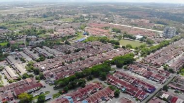 Top Aerial View Of Housing And City In Malaysia With Beautiful Mountain Views and Trees