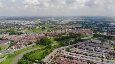 Top Aerial View Of Housing And City In Malaysia With Beautiful Mountain Views and Trees