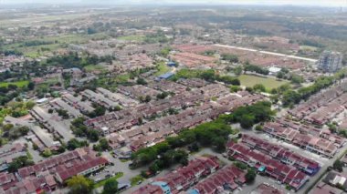 Top Aerial View Of Housing And City In Malaysia With Beautiful Mountain Views and Trees