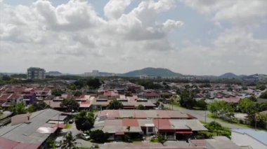 top Aerial View of Residential Housing in Melaka Malaysia with Mountain View - Moving Up.