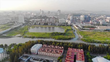 Top Aerial View of Red and White Apartments with Many Trees and Fields