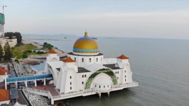 Top Aerial View of the Beautiful White Mosque Beside the Sea with City Views