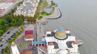 Top Aerial View of the Beautiful White Mosque Beside the Sea with City Views