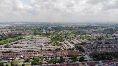Top Aerial View Of Housing And City In Malaysia With Beautiful Mountain Views and Trees