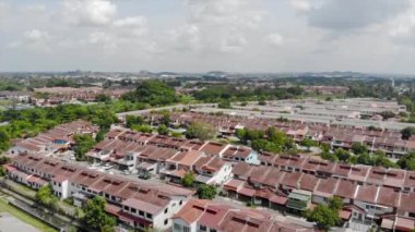 Top Aerial View Of Housing And City In Malaysia With Beautiful Mountain Views and Trees