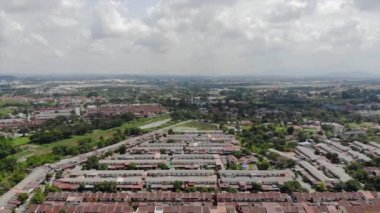 Top Aerial View Of Housing And City In Malaysia With Beautiful Mountain Views and Trees