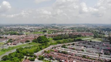 Top Aerial View Of Housing And City In Malaysia With Beautiful Mountain Views and Trees
