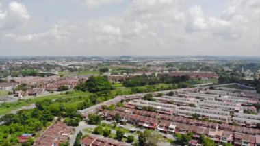 Top Aerial View Of Housing And City In Malaysia With Beautiful Mountain Views and Trees
