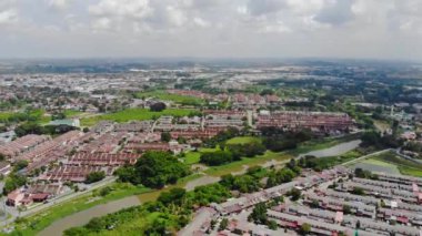 Top Aerial View Of Housing And City In Malaysia With Beautiful Mountain Views and Trees