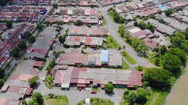 Top View of River Near Housing and Green Trees in Melaka Malaysia - Tilt U