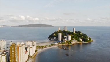  Top Are View Of A Small Island With White Skyscrapers Near A Beautiful Beach And Mountains - Backwards