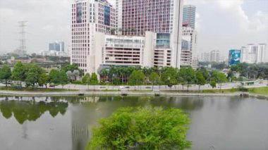  Top Aerial View of lake with a garden full of trees in the city of Malaysia