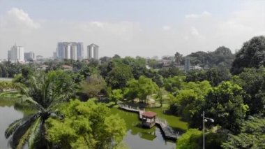 Top Aerial View of lake with a garden full of trees in the city of Malaysia