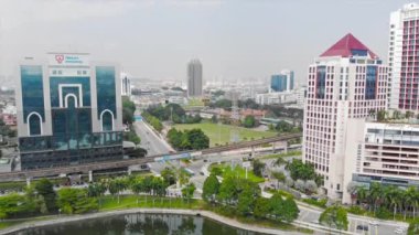  Top Aerial View of lake with a garden full of trees in the city of Malaysia