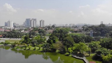  Top Aerial View of lake with a garden full of trees in the city of Malaysia