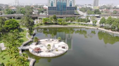  Top Aerial View of lake with a garden full of trees in the city of Malaysia