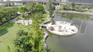  Top Aerial View of lake with a garden full of trees in the city of Malaysia