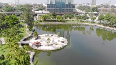  Top Aerial View of lake with a garden full of trees in the city of Malaysia