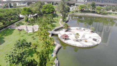  Top Aerial View of lake with a garden full of trees in the city of Malaysia