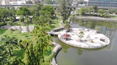  Top Aerial View of lake with a garden full of trees in the city of Malaysia