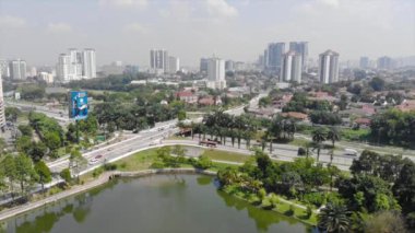  Top Aerial View of lake with a garden full of trees in the city of Malaysia
