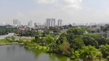  Top Aerial View of lake with a garden full of trees in the city of Malaysia