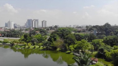  Top Aerial View of lake with a garden full of trees in the city of Malaysia