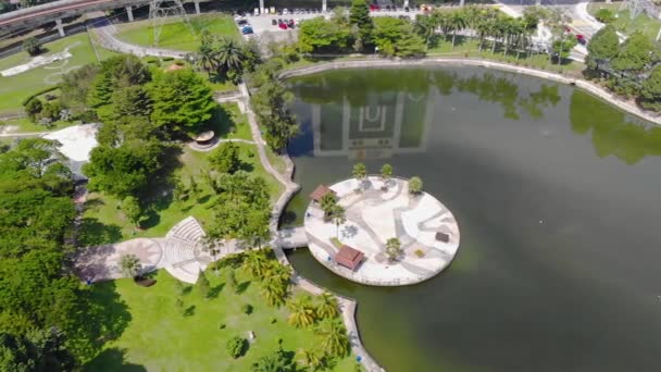 Top Aerial View Green Lake Roundabouts Reflections Buildings Park Dolly — Video