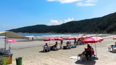 A beautiful beach with green mountains on a Brazilian Island city - Aerial - Crane Up