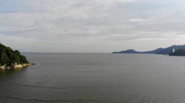  Aerial view of the Atlantic Ocean with green mountains - Crane Dow