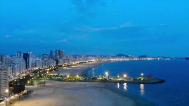 Front night aerial view of the city of Santos - Crane down.