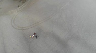 Top aerial view a sandy beach with people - Pan righ
