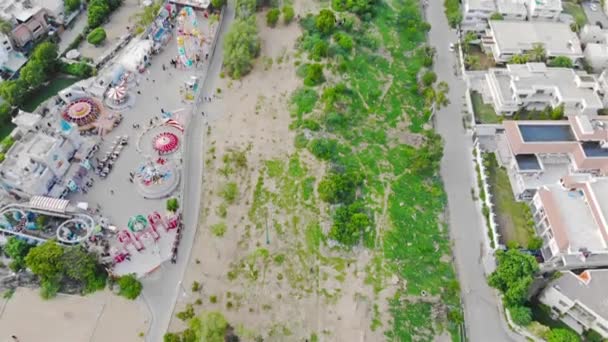 Top View Green Fields White Housing Colorful Amusement Park Μετάβαση — Αρχείο Βίντεο