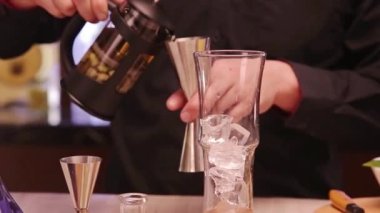 Pouring Liquid From A Black Glass - Close Up