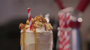 Kırmızı ve Beyaz Çizgili Çubuklar Sıvı Karamelli İçeceğin Üstü