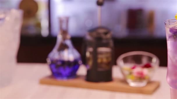 Beautiful Purple Drink Garnish Flowers Slide Left Right — Video