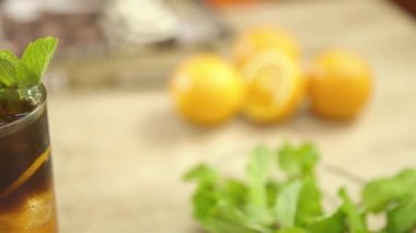 Garnish Sliced Orange And Leaves In A Fresh Drink - Slide Right To Left.