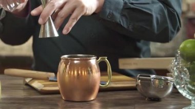 Measuring Water With Jigger Cup To Small Jug - Close Up