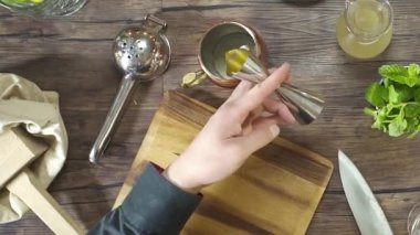 Pouring Yellow Liquid From Jigger Cup.