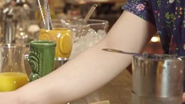 Adding Yellow Liquid to the Tiki Glass 