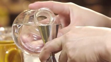 Pouring Water Into a Shaker With Jigger - Close Up