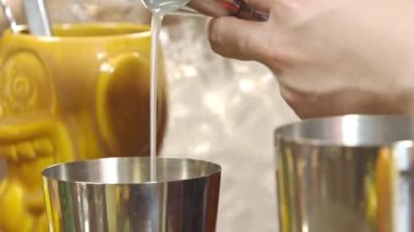Pouring White Liquid Into Shaker With Jigger - Close Up