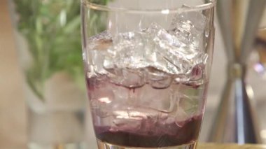 Pour Water Into Glass With Syrup - Close Up