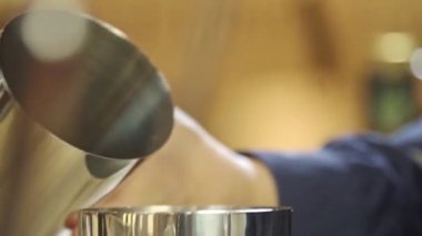 Pour Black Liquid Into Another Shaker Then Close - Close Up.
