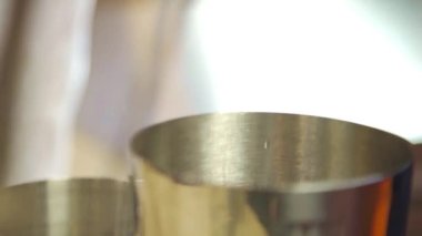 Pouring Black Liquid Into a Small Shaker - Close Up