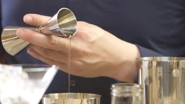  Pouring Yellow Liquid From Jigger To A Small Shaker - Close Up